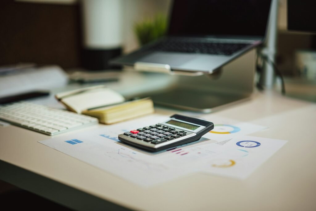 Calculatrice posée à côté d’un ordinateur portable pour estimer le prix d’un site vitrine